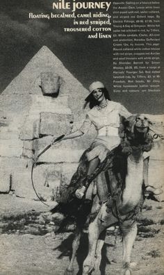 an old photo of a woman riding a camel in front of the pyramids and egyptian architecture