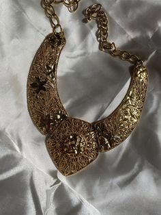 Such a great collectible! This is a vintage gold tone necklace signed Barrera for Avon. The clasp is a hook. Not real gold. It's costume jewelry. Dimensions: Total length - approx. 18 inches, adjustable to be smaller *Note that like most vintage pieces, there is a little wear and tarnish on this item from age. Vintage Brass Choker Jewelry, Vintage Brass Choker Necklace, Gold Decorative Metal Jewelry, Yellow Gold Costume Jewelry Necklace, Elegant Decorative Gold Jewelry, Gold-tone Necklace With Vintage Charm, Vintage Gold Plated Necklaces For Weddings, Gold-plated Jewelry With Vintage Charm, Antique Gold Jewelry With Vintage Charm