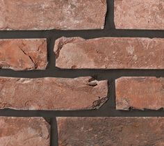 a brick wall that is made out of red bricks and has no mortar on it