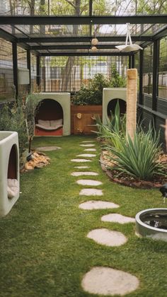 a person standing in front of a dog house with grass and stepping stones on the ground