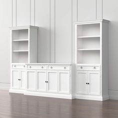 two white bookshelves in an empty room