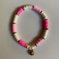 Pink & white clay bead seashell bracelet White Shell Bracelet For Vacation, White Shell-shaped Beaded Bracelets For Vacation, White Beaded Pearl Bracelet For Vacation, White Hand-strung Bracelets For Vacation, Handmade White Pearl Bracelet For Vacation, Hand-strung White Bracelets For Vacation, White Hand-strung Bracelet For Vacation, White Shell-shaped Bracelet As A Gift, White Shell-shaped Bracelet For Gift