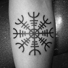 a black and white photo of a tattoo on the leg