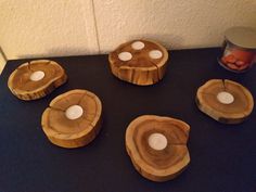 four pieces of wood sitting on top of a table next to an empty canister