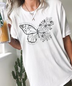 "Christian Butterfly Shirt with \"New Creation in Christ\" Design. Put your faith on display with this trendy graphic tee! This classic unisex jersey short sleeve tee fits like a well-loved favorite. Soft cotton and quality print make users fall in love with it over and over again. These t-shirts have-ribbed knit collars to bolster shaping. The shoulders have taping for better fit over time. Dual side seams hold the garment's shape for longer.  .: 100% Airlume combed and ringspun cotton (fiber c Inspirational Short Sleeve Shirt With Graphic Print, Inspirational Graphic Print Short Sleeve Shirt, Inspirational Short Sleeve Graphic Print Shirt, Inspirational Custom Print Short Sleeve Top, Inspirational Short Sleeve Top With Custom Print, Inspirational White Shirt With Crew Neck, Inspirational White Shirt With Graphic Print, White Inspirational Relaxed Fit T-shirt, Inspirational White Pre-shrunk T-shirt