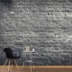 a chair and table in front of a brick wall