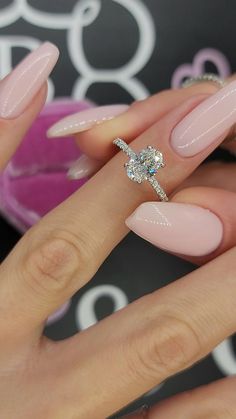 a woman's manicured nails with a diamond ring