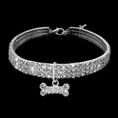 a dog bone charm bracelet with crystal stones on the front and back ends, in white gold