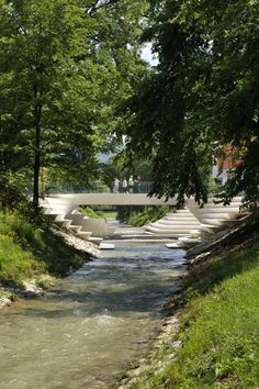 a small river running through a lush green park