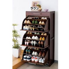 the shoe rack is made out of wood and holds several pairs of shoes on it