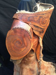 the boots are made out of wood and have been decorated with leather, which is being displayed