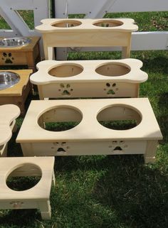 several wooden bowls are lined up on the grass