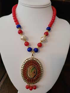 Hand painted portrait peacock necklace.  Beaded chain has 8mm to 10mm red/blue onyx and freshwater pearl.  Clear and orange Austrian crystal.  Gold electroplating. Festive Red Pearl Chain Jewelry, Red Beaded Chain Necklace For Festivals, Traditional Pearl Beaded Chain Jewelry, Traditional Pearl Necklaces With Colorful Beads, Red Pearl Beaded Necklaces With Pearl Chain, Red Pearl Necklace With Round Beads, Festive Multicolor Pearl Necklaces, Red Pearl Necklace With Pearl Chain, Red Pearl Jewelry With Colorful Beads