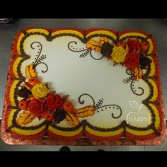 a square cake decorated with orange and yellow flowers