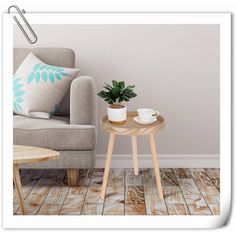 a living room with a couch, coffee table and potted plant on the side