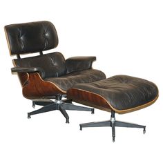 an eames lounge chair and ottoman with black leather