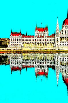 a large white building sitting on top of a lake next to a tall clock tower