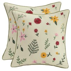 two white pillows with colorful flowers on them