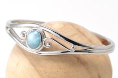 "Material:100% 925 Sterling Silver with White Gold Plated Main stone:Larimar Gemstone Other stone:N/A Size:2.32\" x 1.85\" Condition:New Main color:Blue Quantity:1 Pcs This bracelet is made with 100% natural genuine rare Larimar stone from Dominican Republic and solid 925 sterling silver w/ Rhodium gold plating for better quality and prolonged shine! Please check my other beautiful silver jewelry: www.etsy.com/shop/Chainstones A lab grown gem is a man-made material with essentially the same chem Elegant Larimar Bracelet Jewelry, Elegant Round Larimar Jewelry, Elegant Larimar Cabochon Jewelry, Larimar Bracelet Jewelry Gift, Elegant Turquoise Larimar Bracelets, Silver Larimar Bracelets As Gift, Adjustable Silver Bracelet, Handmade Silver Rings, Rings Stones