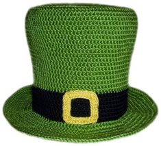 a green crocheted hat with a yellow buckle on the front and black band around the brim