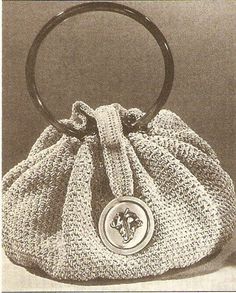 an old photo of a purse with a circular handle