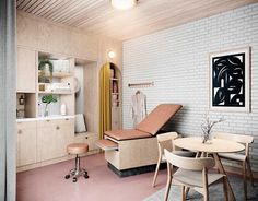 a living room with white brick walls and wooden furniture in the corner, along with a small dining table