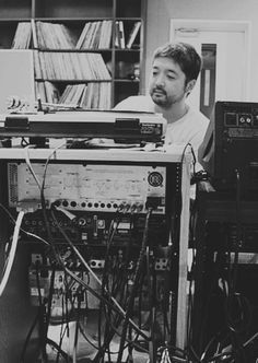 a man is sitting in front of some electronic equipment