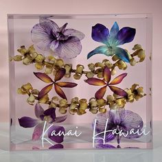 there is a glass block with flowers in it that says kauai hawaiii