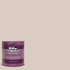 the behr ultra paint is shown in an open tin with a light brown background