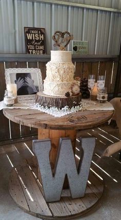 a wedding cake sitting on top of a wooden table