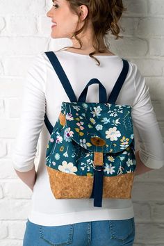 a woman wearing a backpack with flowers on it