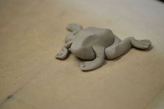 a clay animal laying on top of a table