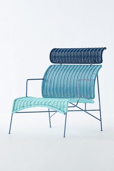 a blue chair sitting on top of a white floor next to a metal frame structure