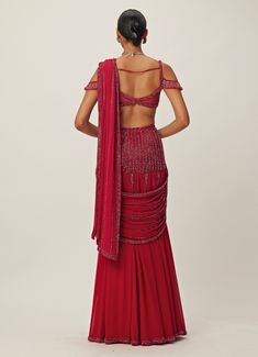 Step into the spotlight and radiate confidence and grace with the Ruby Red Pre-Draped Crystal Embroidered Georgette Saree Set, a captivating blend of elegance and modern style. Crafted from luxurious georgette, the pre-draped red saree features intricate tonal hand embroidery adorned with cutdana and crystal embellishments, adding a touch of sparkle and sophistication. Paired with an off shoulder jewelled blouse embellished with matching crystal details which adds a chic detail. Perfect ready to Vani Vats, Red Drapes, Radiate Confidence, Vacuum Storage, Ready To Wear Saree, Indian Wedding Wear, Red Saree, Sleeves Blouse, Wear Saree