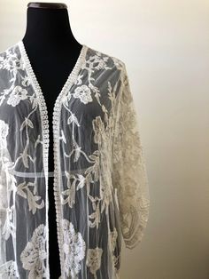 "This overlayering piece is made with soft embroidered sheer lace, features mid sleeve with scalloped sleeve edge and hem. Makes for a super sweet cover up for any outfit! ONE SIZE FITS MOST - SMALL, MEDIUM, LARGE Length: 37\" Bust: 23\" (open front, one size fits all) Armhole: 11\" Now when you order two items or more, your shipping is on us! Enter FREESHIP at checkout! ( US shipping only) And/Or Share your photo with me in the item you purchased, you will receive a $15 coupon toward your next Fitted Lace Cover-up With Lace Trim, Bohemian Fitted Sheer Cover-up, Bohemian Lace Patchwork For Spring, Fitted Bohemian Lace For Spring, Bohemian Fitted Lace For Spring, Spring Sheer Long Sleeve Kimono, Bohemian Long Sleeve Outerwear For Wedding, Embroidered Open Front Cardigan, Bohemian Cream Lace For Spring