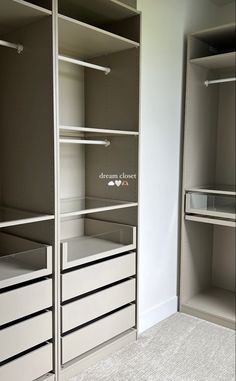 an empty walk in closet with drawers and shelves