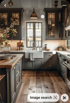 a kitchen with wooden floors and gray cabinets