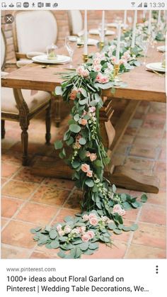 the table is set with flowers and candles