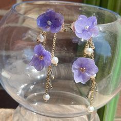 Introducing our stunning Iris Flower Earrings, featuring a charming purple color, evoking an elegant and timeless appeal. The dangles showcase intricately designed blooming flowers, adding a cute and elegant touch to your look. Crafted with hypoallergenic materials, these earrings offer a comfortable and safe wearing experience. The lightweight design makes them perfect for everyday wear or as an exquisite accessory for formal events. Ideal for various occasions, including weddings, parties, or adding a touch of elegance to your daily outfits. Elevate your style effortlessly with these lightweight, easy-to-wear, and meticulously detailed Iris Flower Earrings, suitable for any occasion that calls for a touch of vintage charm and sophistication. Elegant Dangle Flower Earrings For Mother's Day, Elegant Lavender Flower Earrings For Gift, Mother's Day Gift Dangle Flower Earrings, Mother's Day Gift Flower Dangle Earrings, Elegant Silver Earrings With Pressed Flowers, Elegant Purple Flower Earrings, Elegant Purple Flower Shaped Earrings, Mother's Day Dangle Earrings With Flower Charm, Lavender Flower-shaped Earrings For Gifts