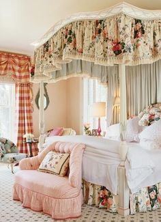 a bed room with a neatly made bed next to a desk and chair in front of a window