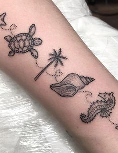 a small tattoo on the arm of a woman with sea animals and palm trees around her