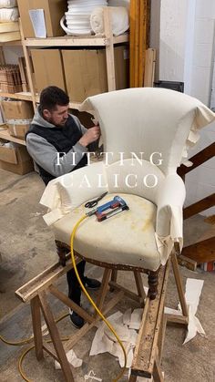 a man working on a chair in a shop