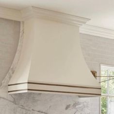 a kitchen with marble counter tops and an oven hood in the middle of the room