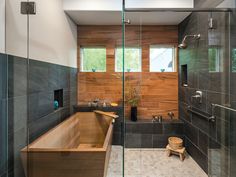 a bath tub sitting inside of a bathroom next to a walk in shower