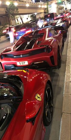 a row of red sports cars parked next to each other