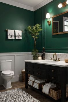 a bathroom with dark green walls and white countertop, black vanity, gold accents