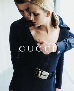 a man and woman standing next to each other with the words gucci on them