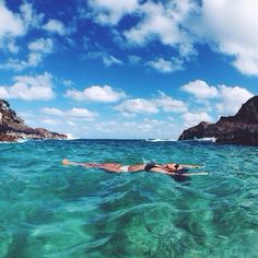 a person laying on their stomach in the ocean