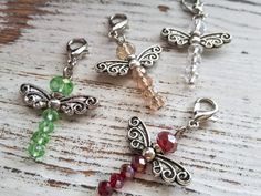 four charms with different colors and designs on them