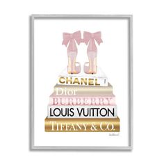 a framed poster with the words chanel and two girls standing on top of books